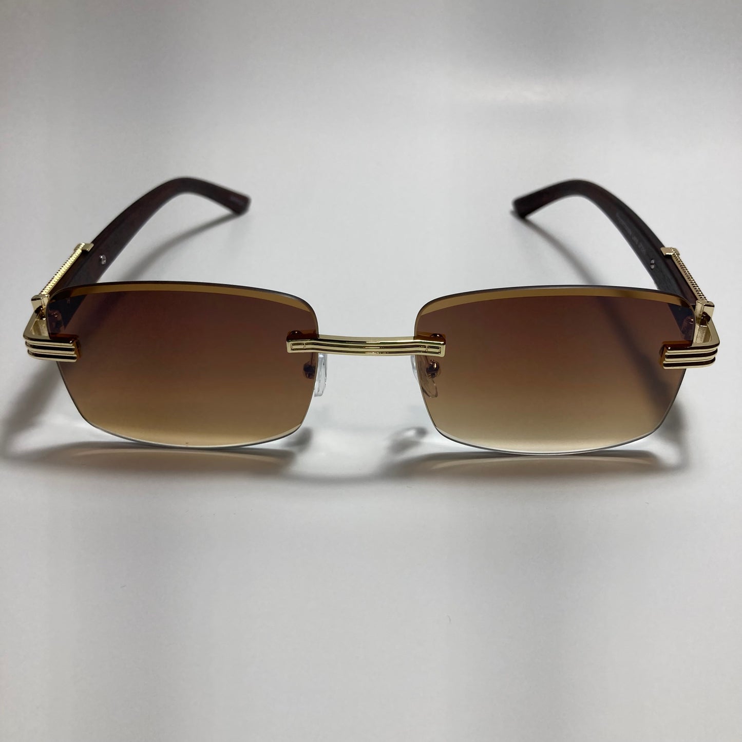 mens and womens gold and brown rimless square sunglasses