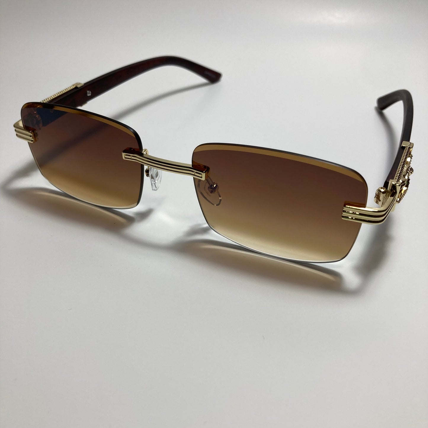 mens and womens gold and brown rimless square sunglasses