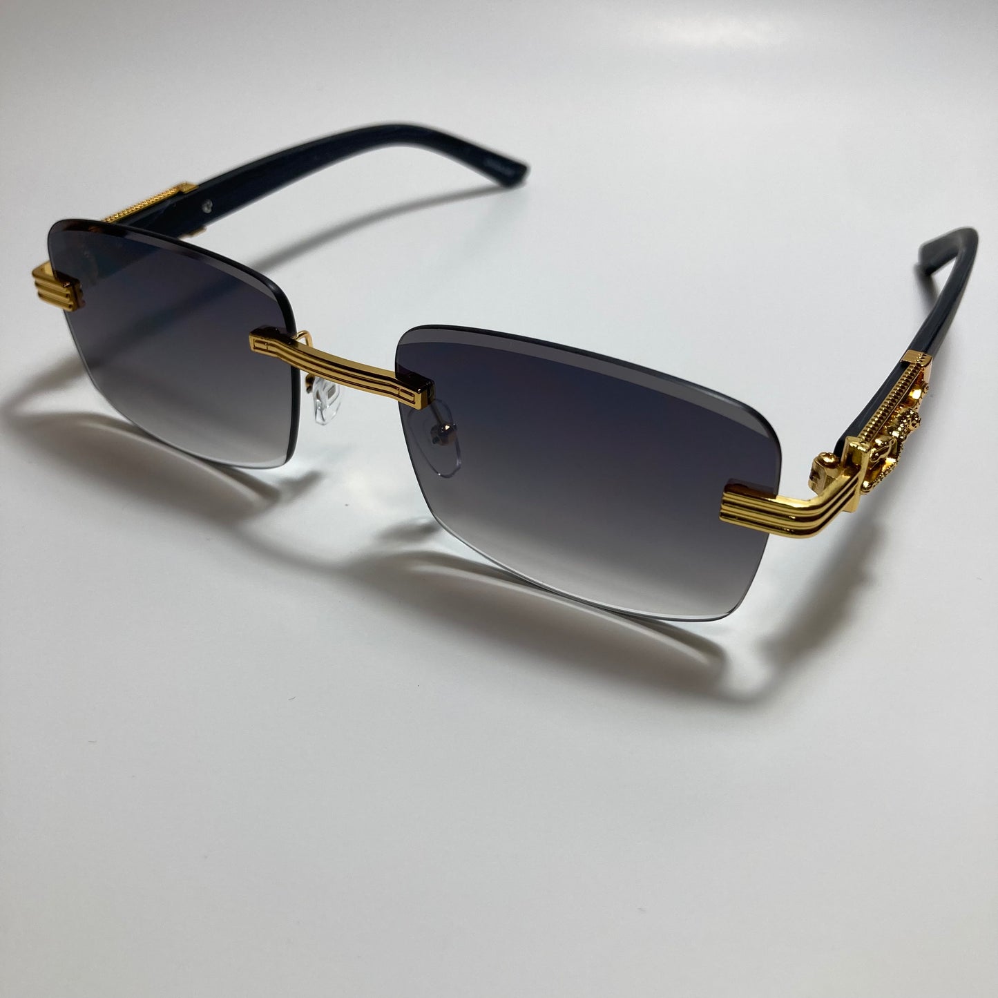mens and womens gold and black rimless square sunglasses