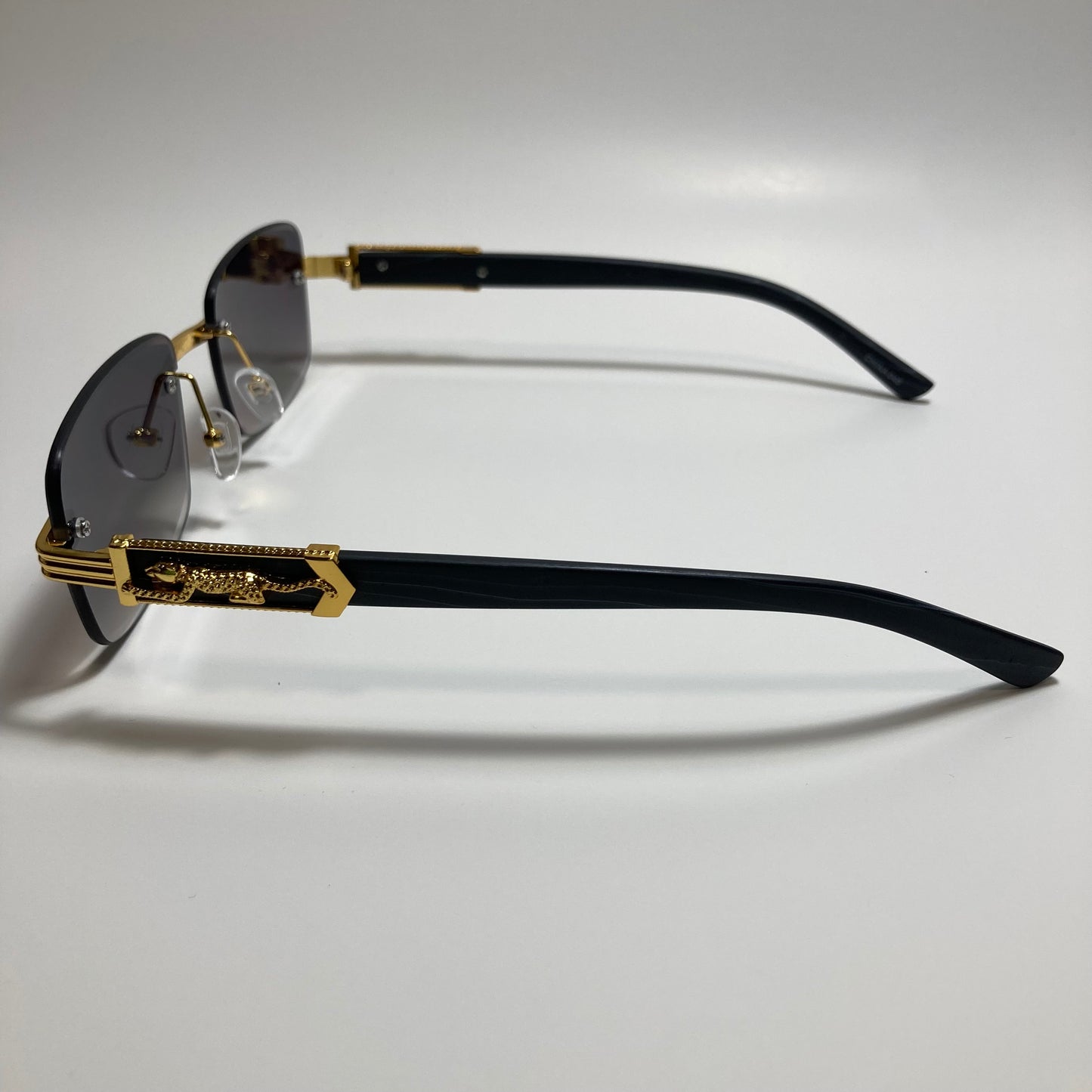 mens and womens gold and black rimless square sunglasses