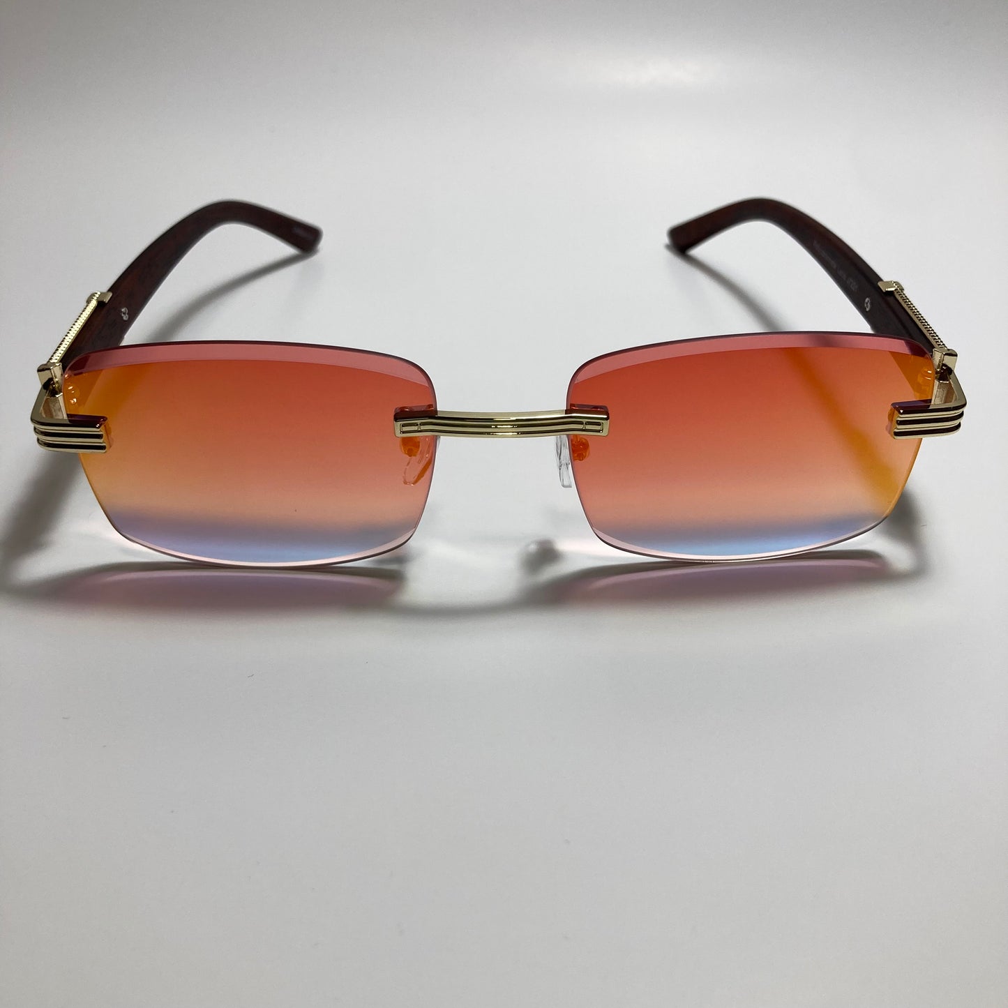 mens and womens gold and orange mirrored rimless square sunglasses