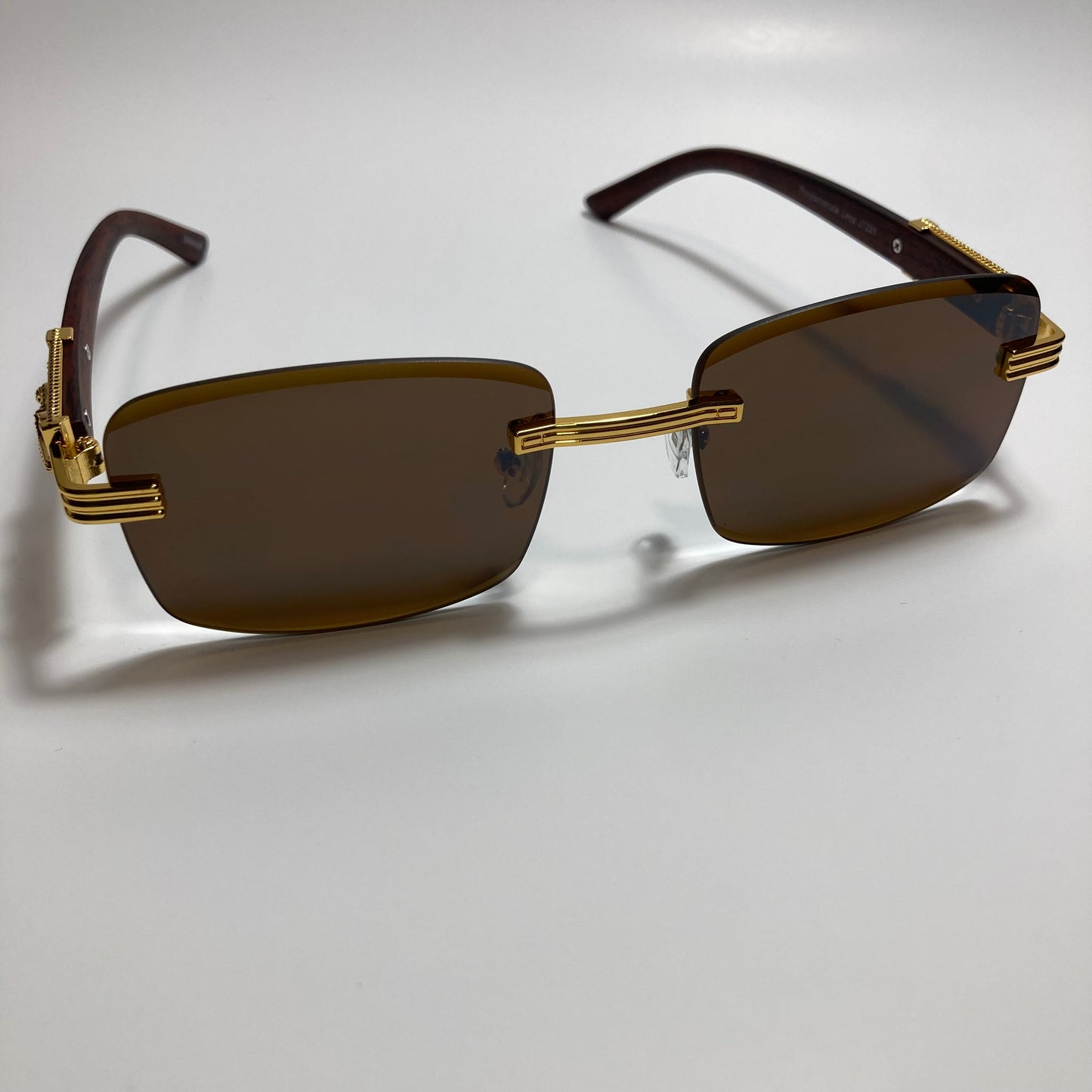 mens and womens gold and brown rimless square sunglasses