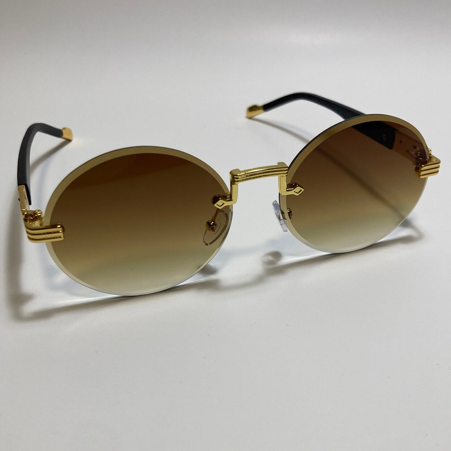 mens and womens rimless round glasses with brown lenses and gold frame
