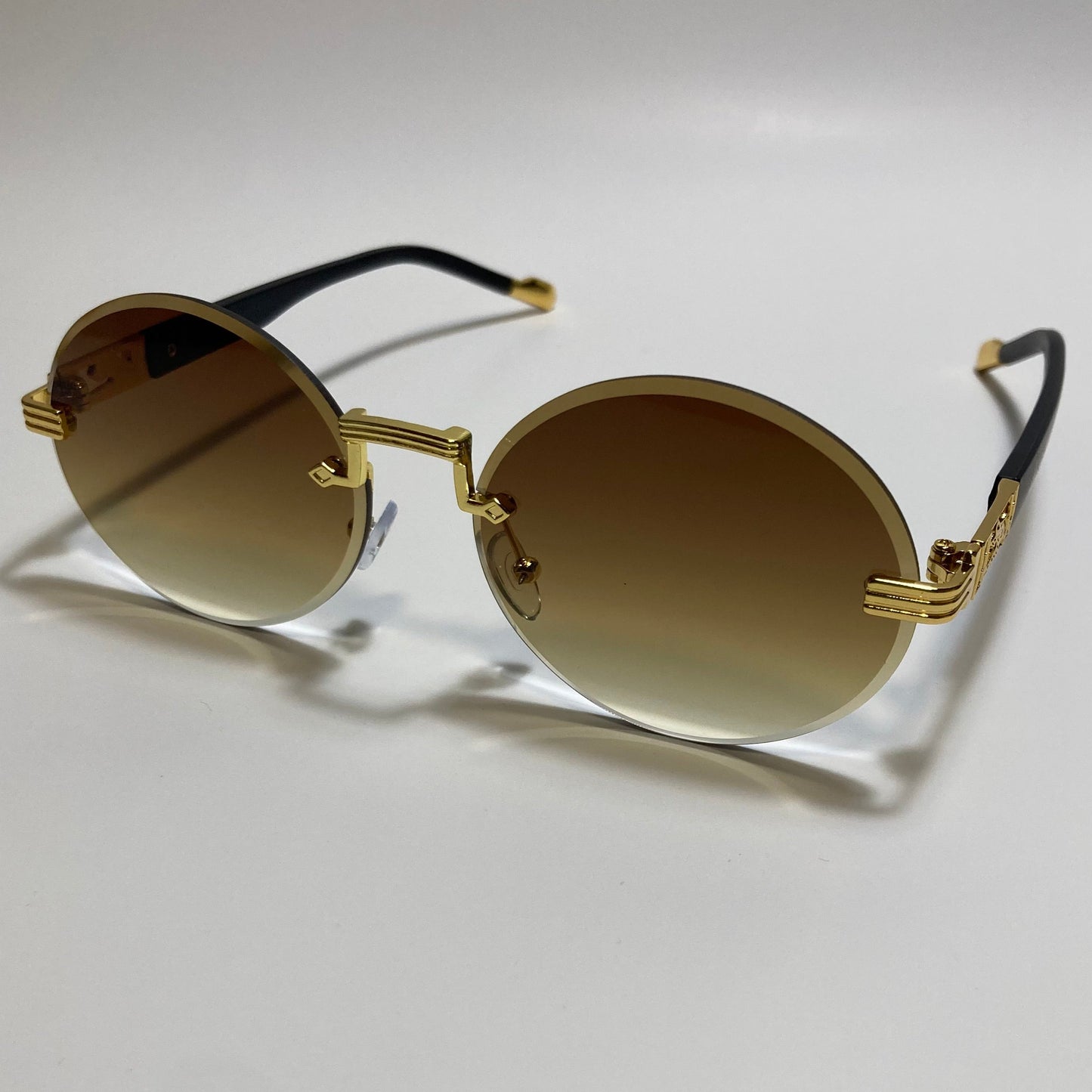 mens and womens rimless round glasses with brown lenses and gold frame