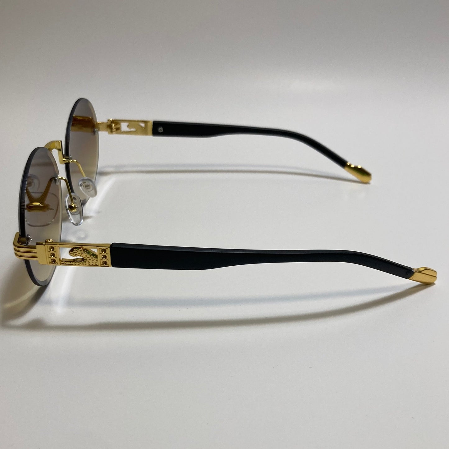 mens and womens rimless round glasses with brown lenses and gold frame