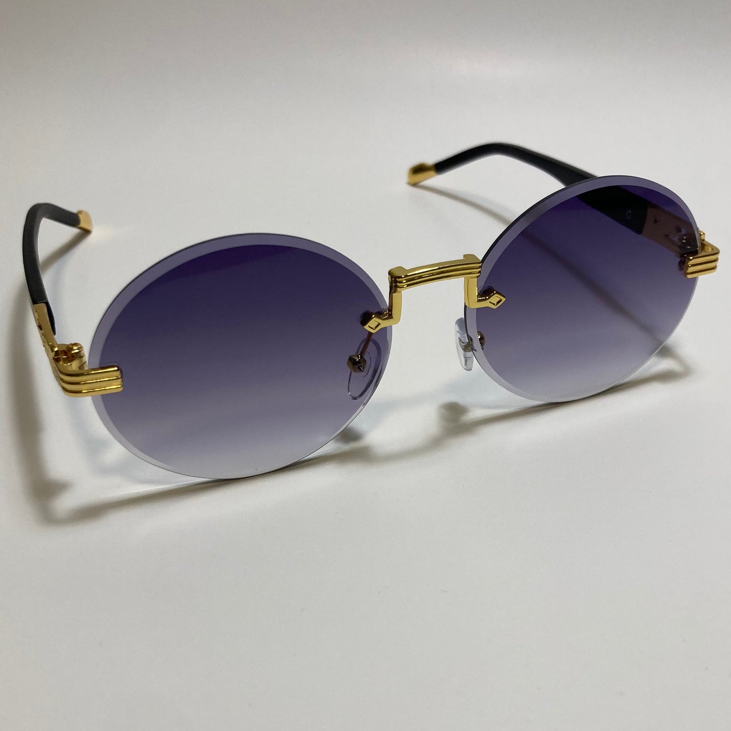 mens and womens rimless round glasses with black lenses and gold frame