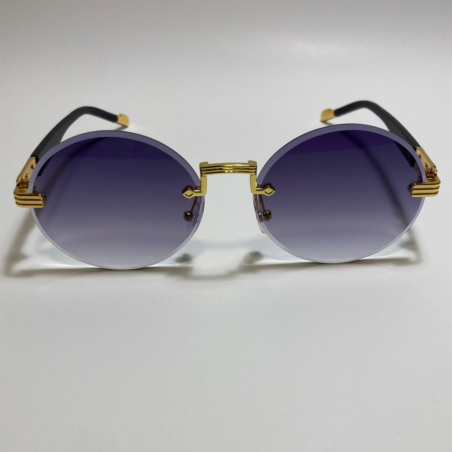mens and womens rimless round glasses with black lenses and gold frame