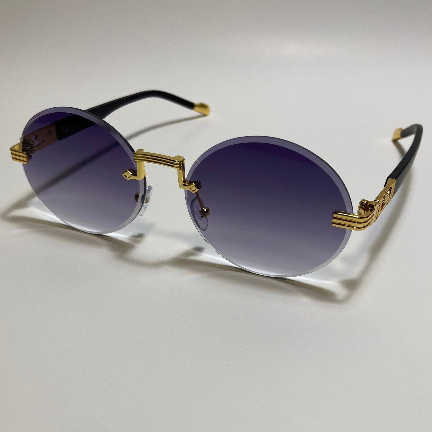mens and womens rimless round glasses with black lenses and gold frame