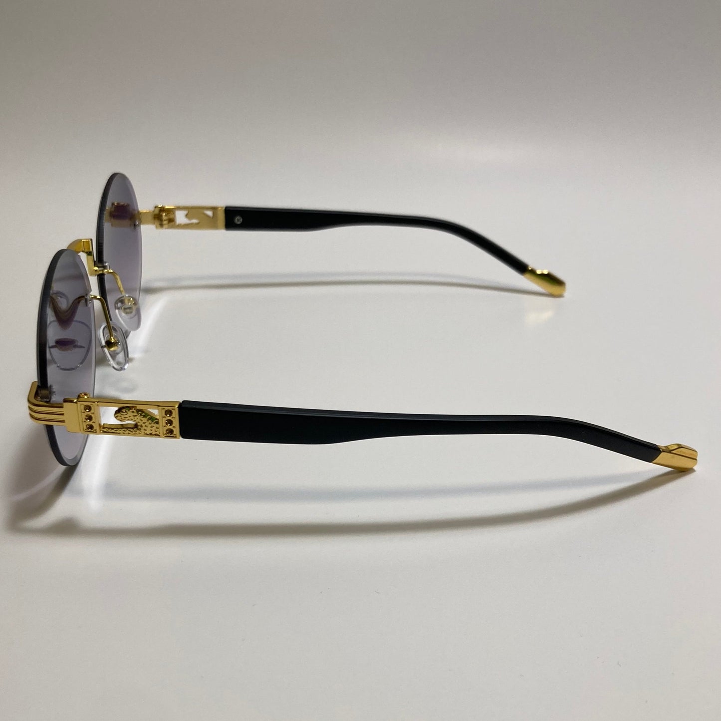 mens and womens rimless round glasses with black lenses and gold frame