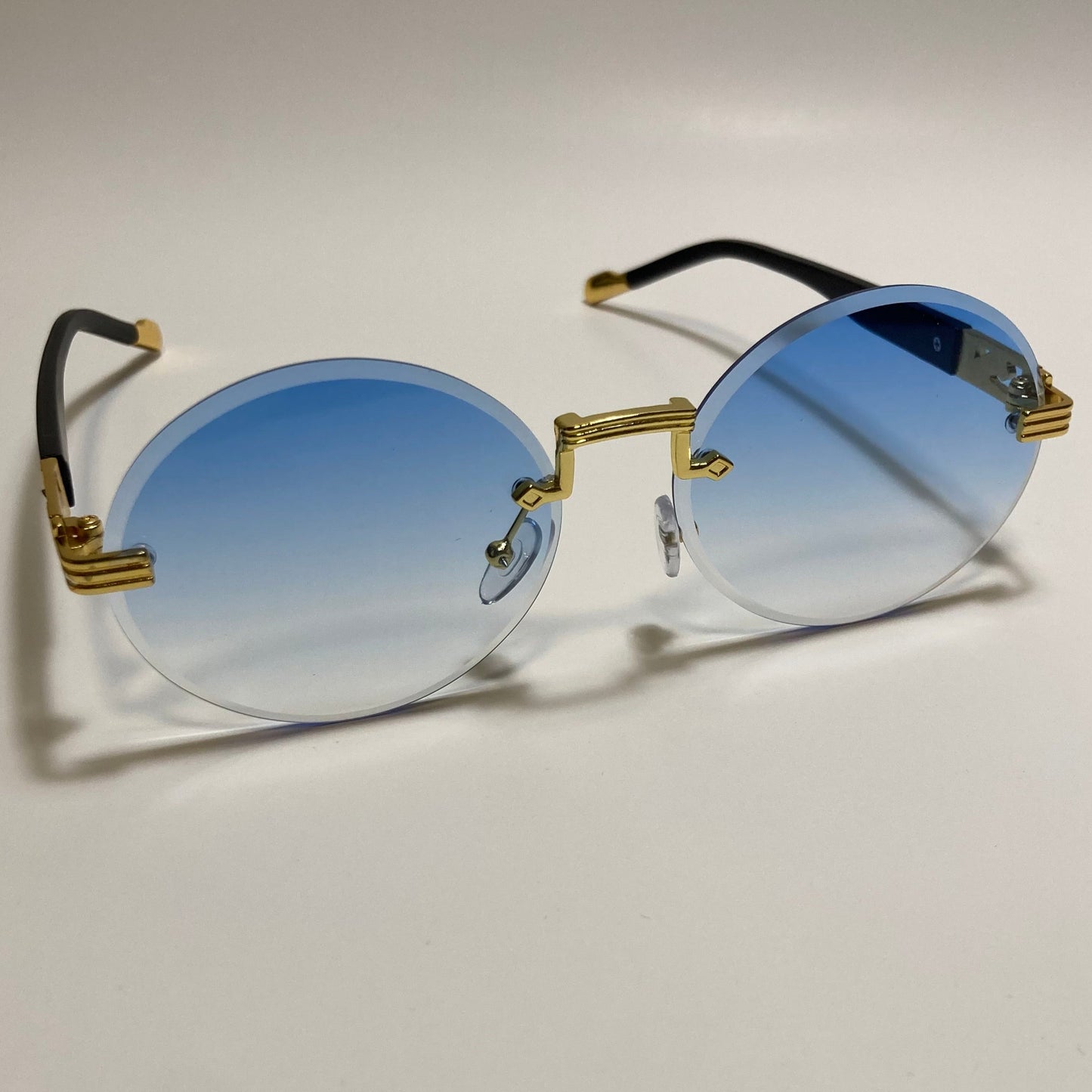mens and womens rimless round sunglasses with blue lenses and gold frame
