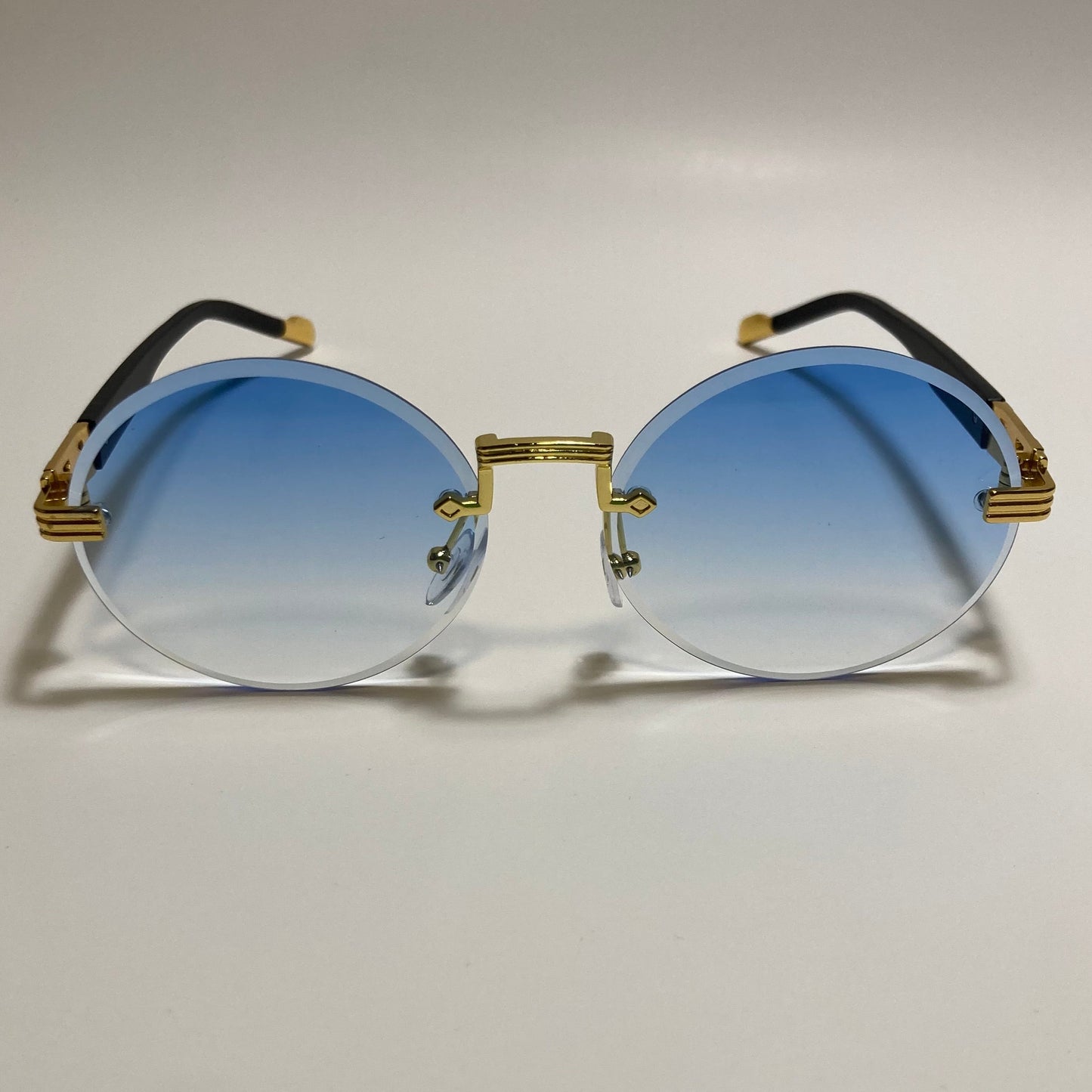 mens and womens rimless round sunglasses with blue lenses and gold frame
