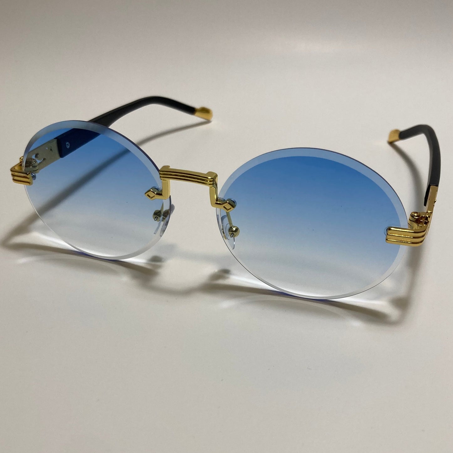mens and womens rimless round sunglasses with blue lenses and gold frame