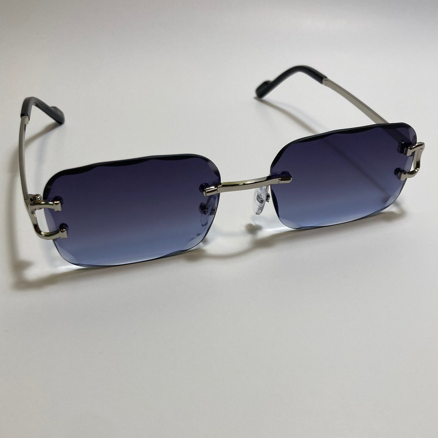 unisex blue and silver rimless oval sunglasses