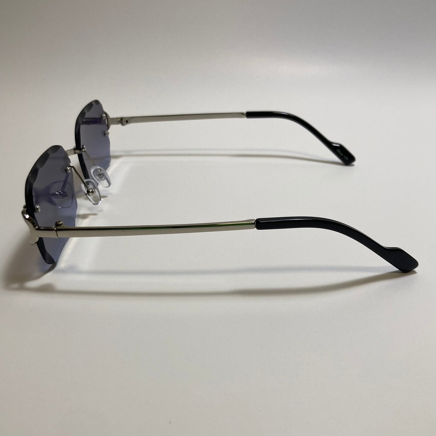 unisex blue and silver rimless oval sunglasses