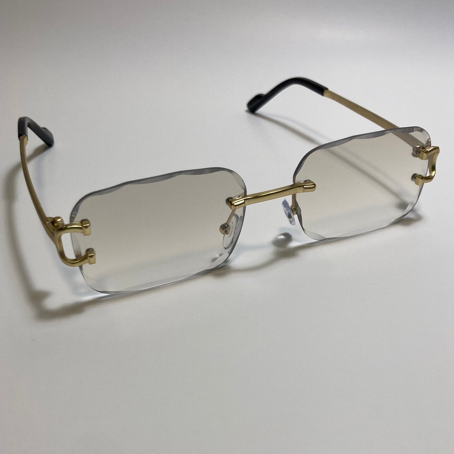 unisex gray and gold rimless oval sunglasses
