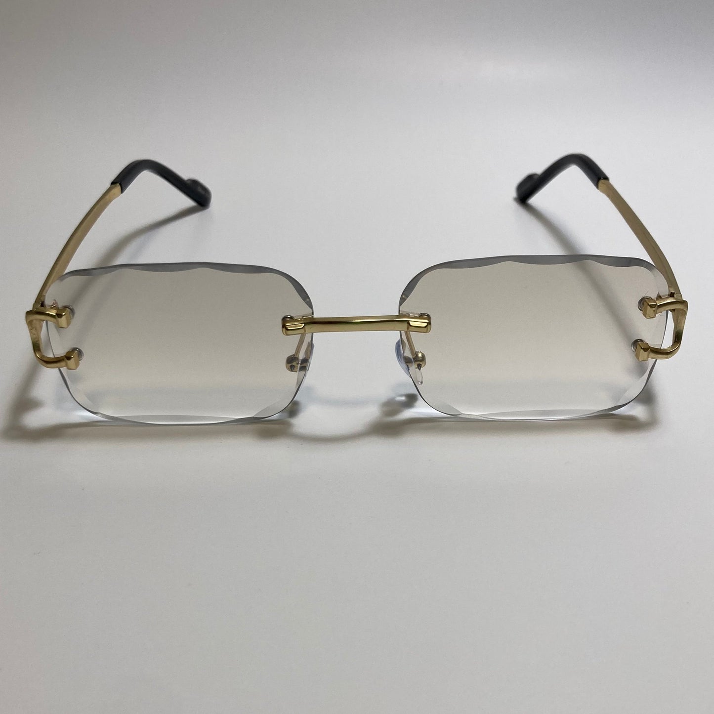 unisex gray and gold rimless oval sunglasses