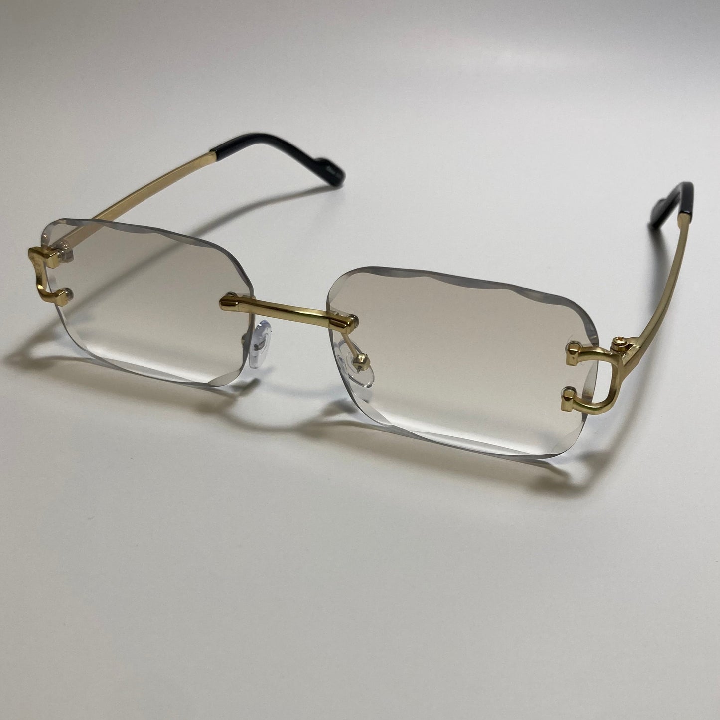 unisex gray and gold rimless oval sunglasses