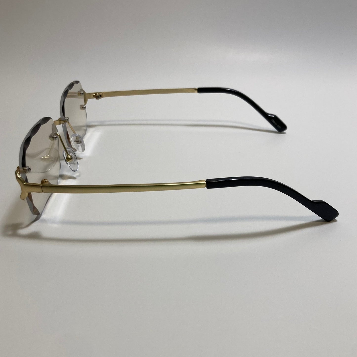unisex gray and gold rimless oval sunglasses