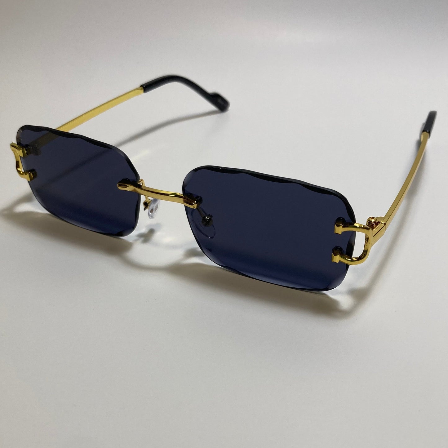 unisex black and gold rimless oval sunglasses