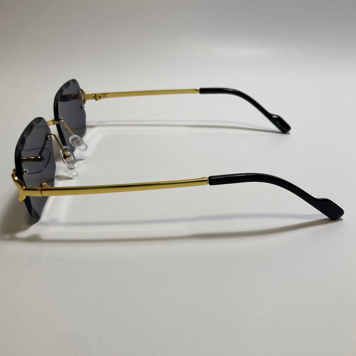 unisex black and gold rimless oval sunglasses