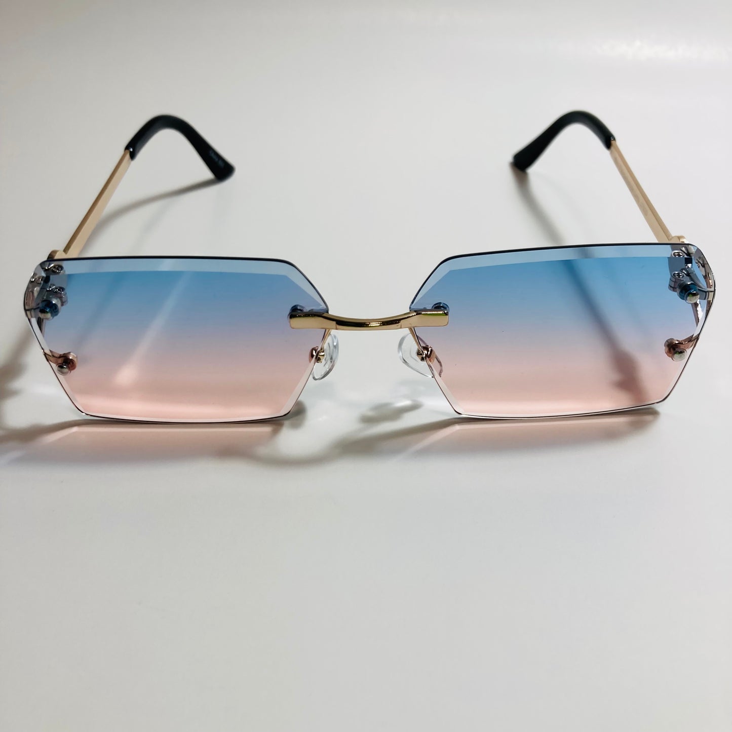 mens and womens blue pink and gold rimless square sunglsses
