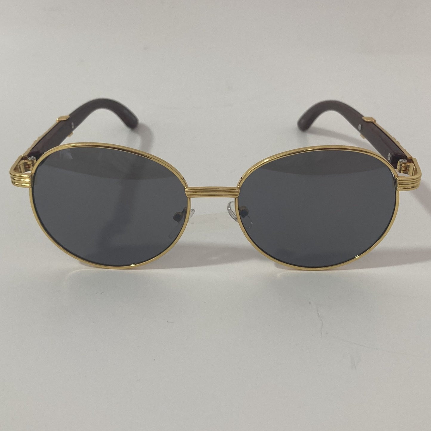 womens and mens gold and black round sunglasses