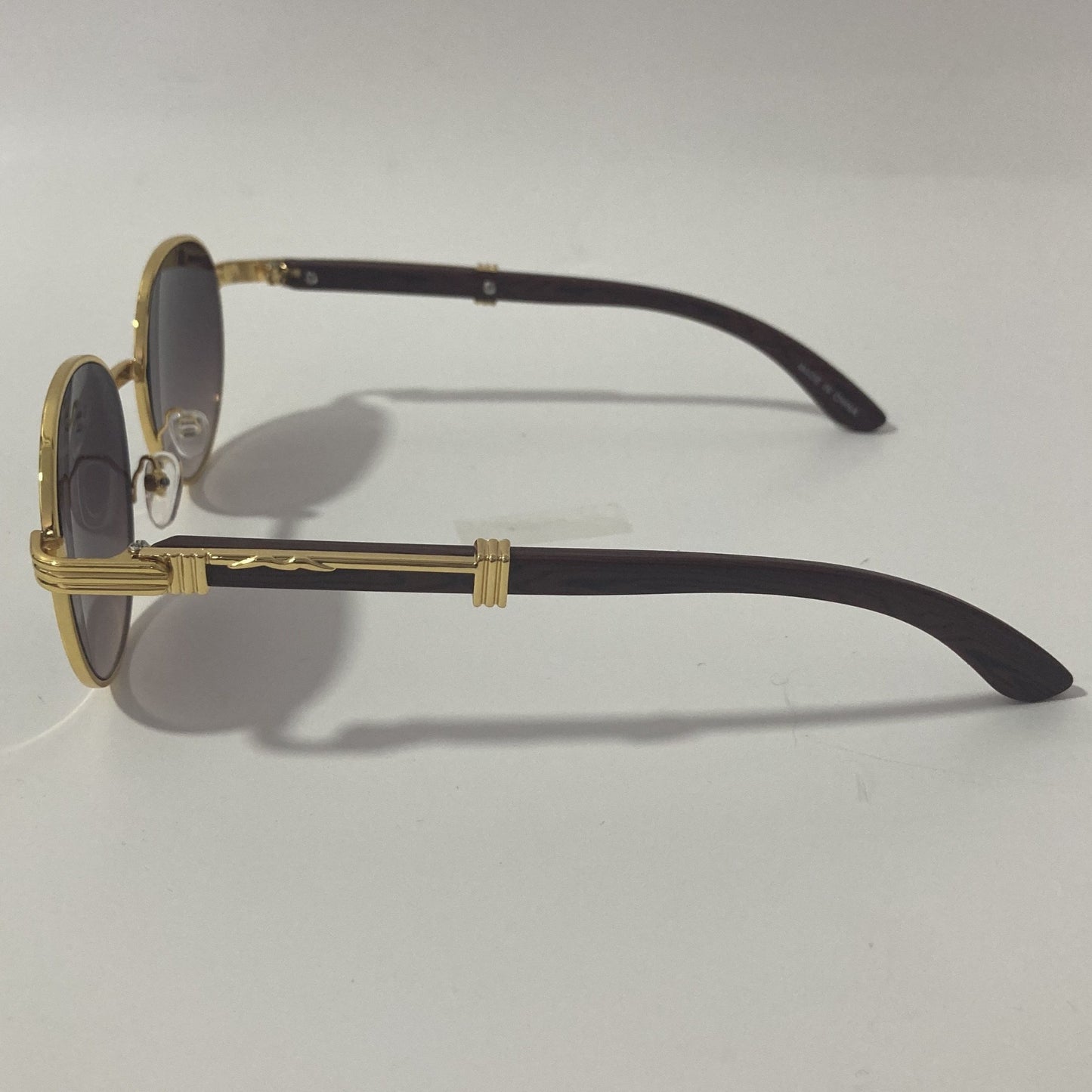 womens and mens gold and black round sunglasses