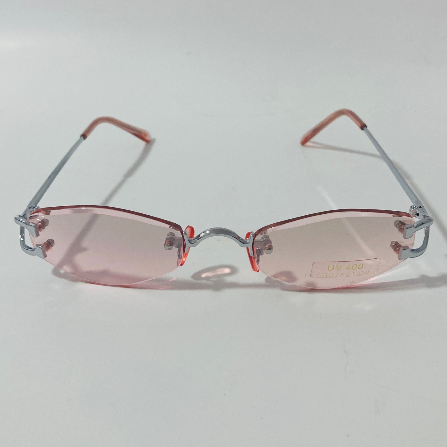 mens and womens silver and pink small rimless sunglasses