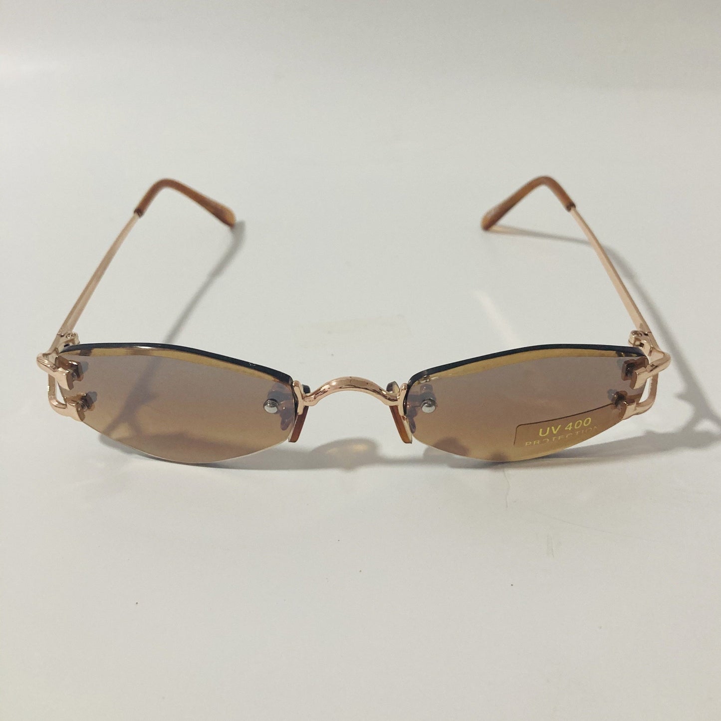 mens and womens brown and gold small rimless sunglasses