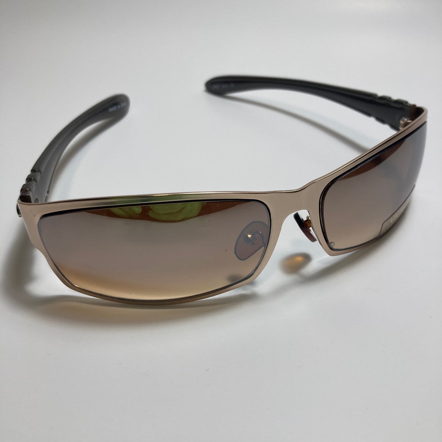 mens and womens brown and gold metal wrap around sunglasses