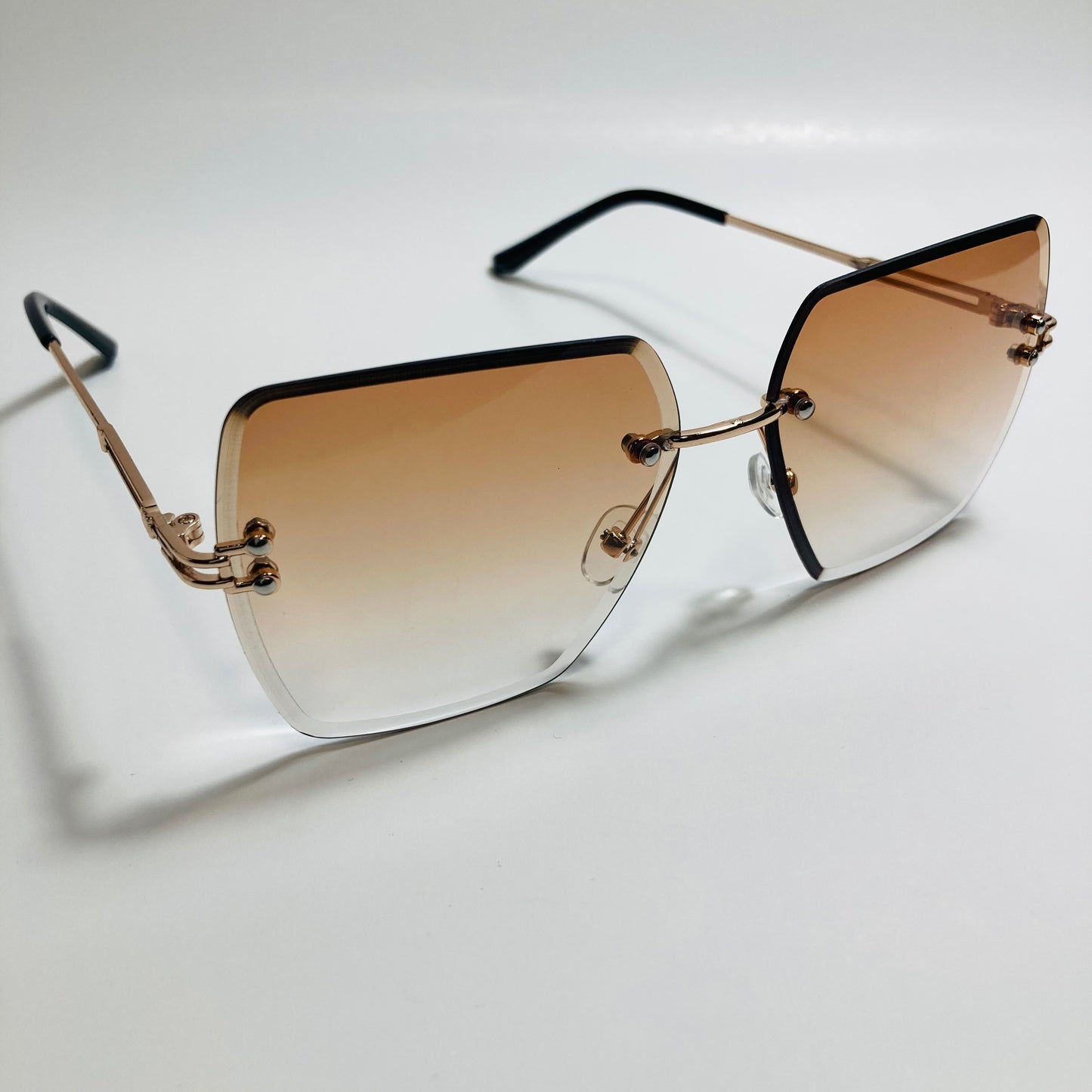 womens brown and gold rimless oversize sunglasses