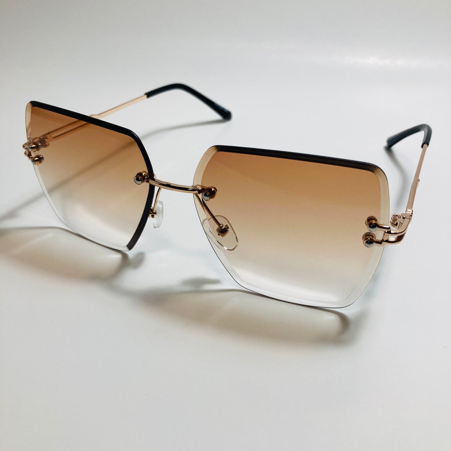 womens brown and gold rimless oversize sunglasses