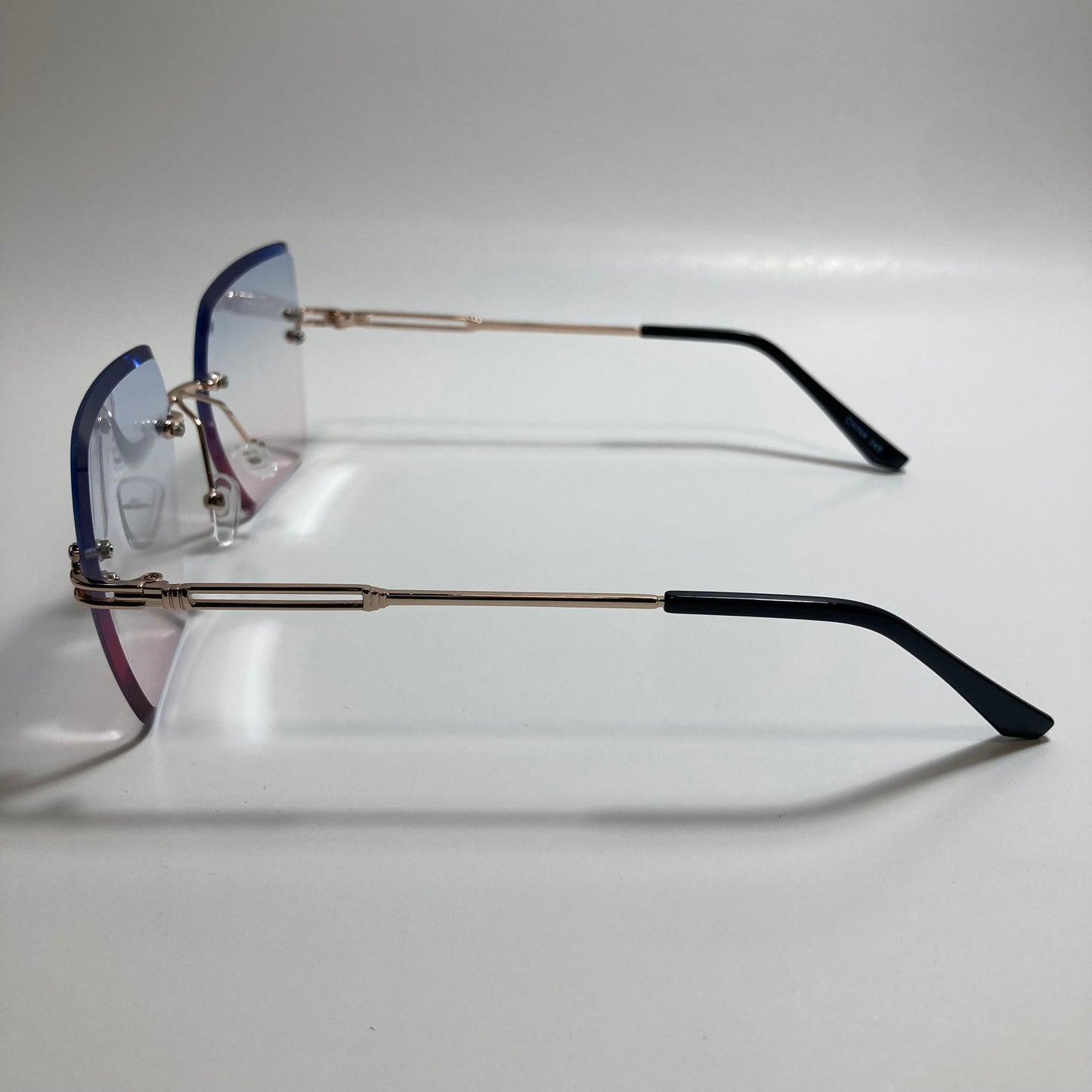 womens blue pink and gold rimless oversize sunglasses