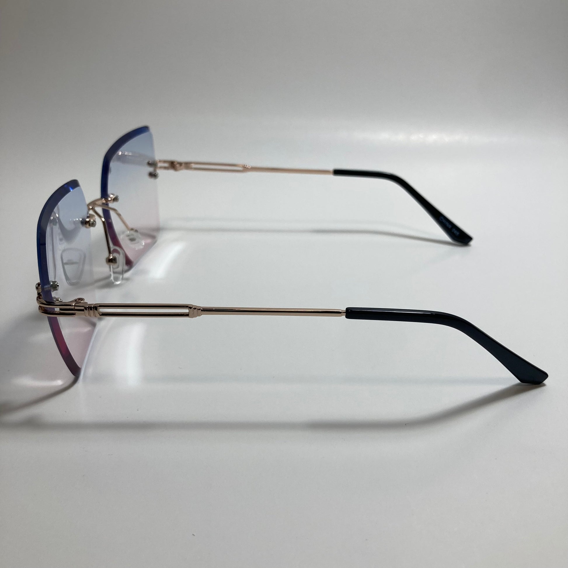 womens blue pink and gold rimless oversize sunglasses