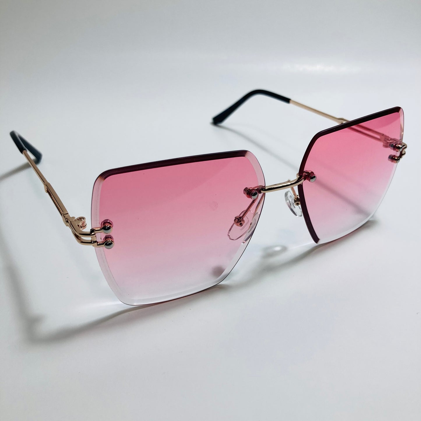 womens pink and gold rimless oversize sunglasses