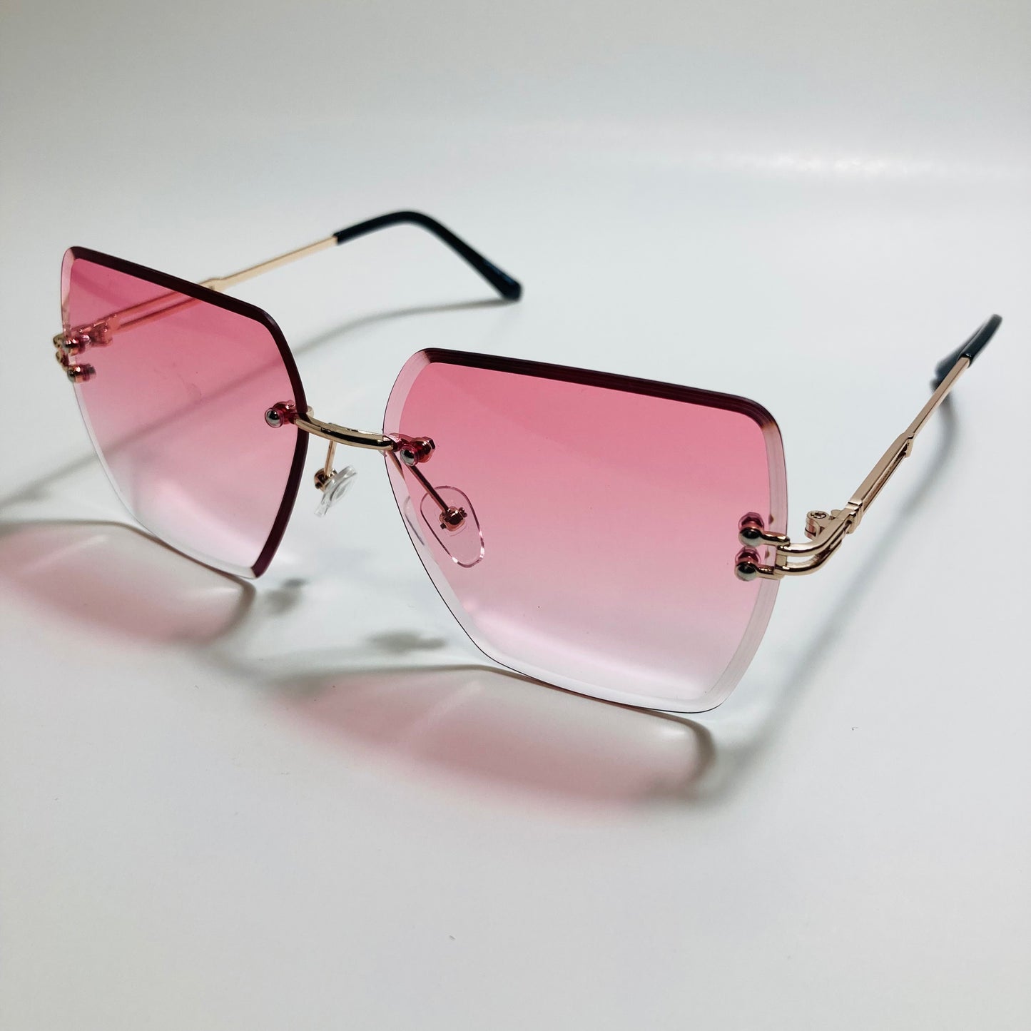 womens pink and gold rimless oversize sunglasses