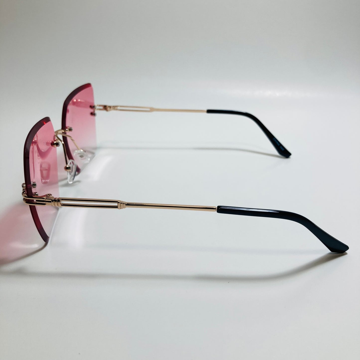 womens pink and gold rimless oversize sunglasses