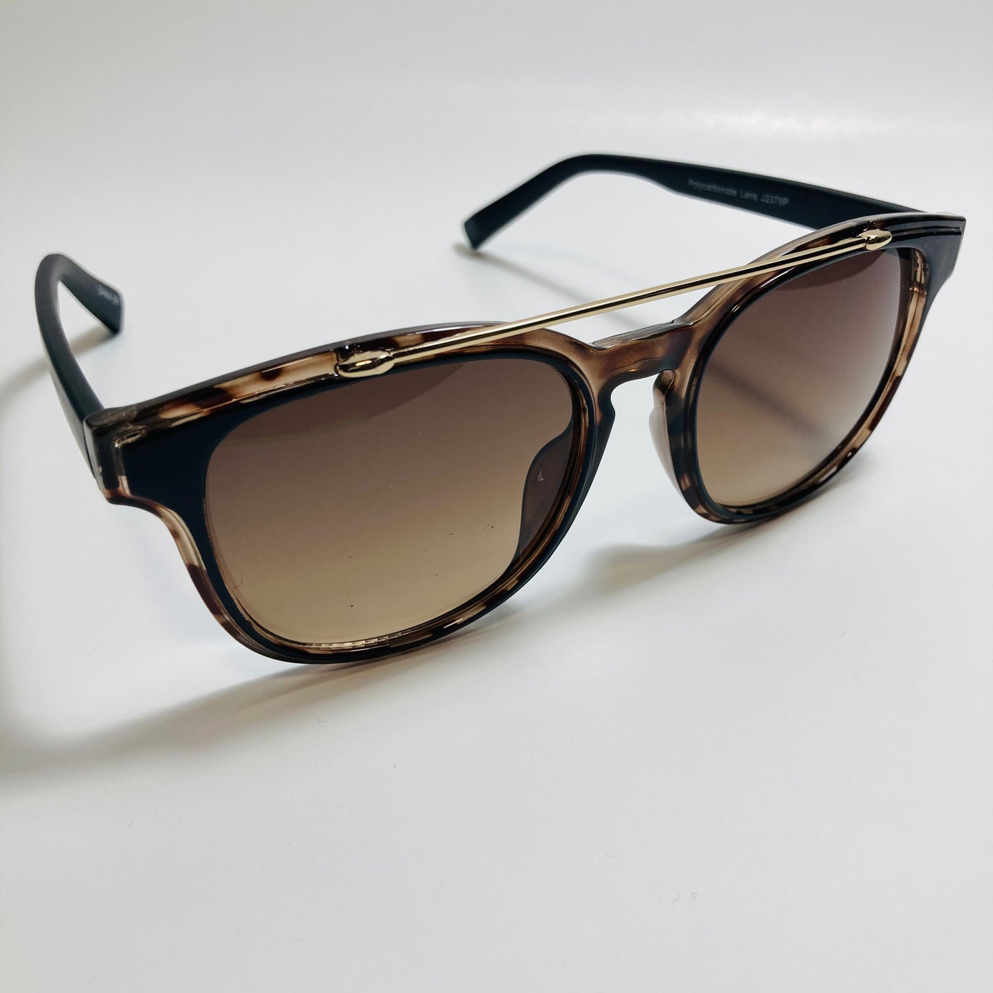 mens and womens brown and black round sunglasses with crossbar