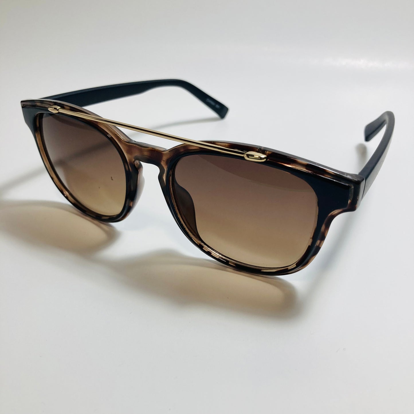 mens and womens brown and black round sunglasses with crossbar