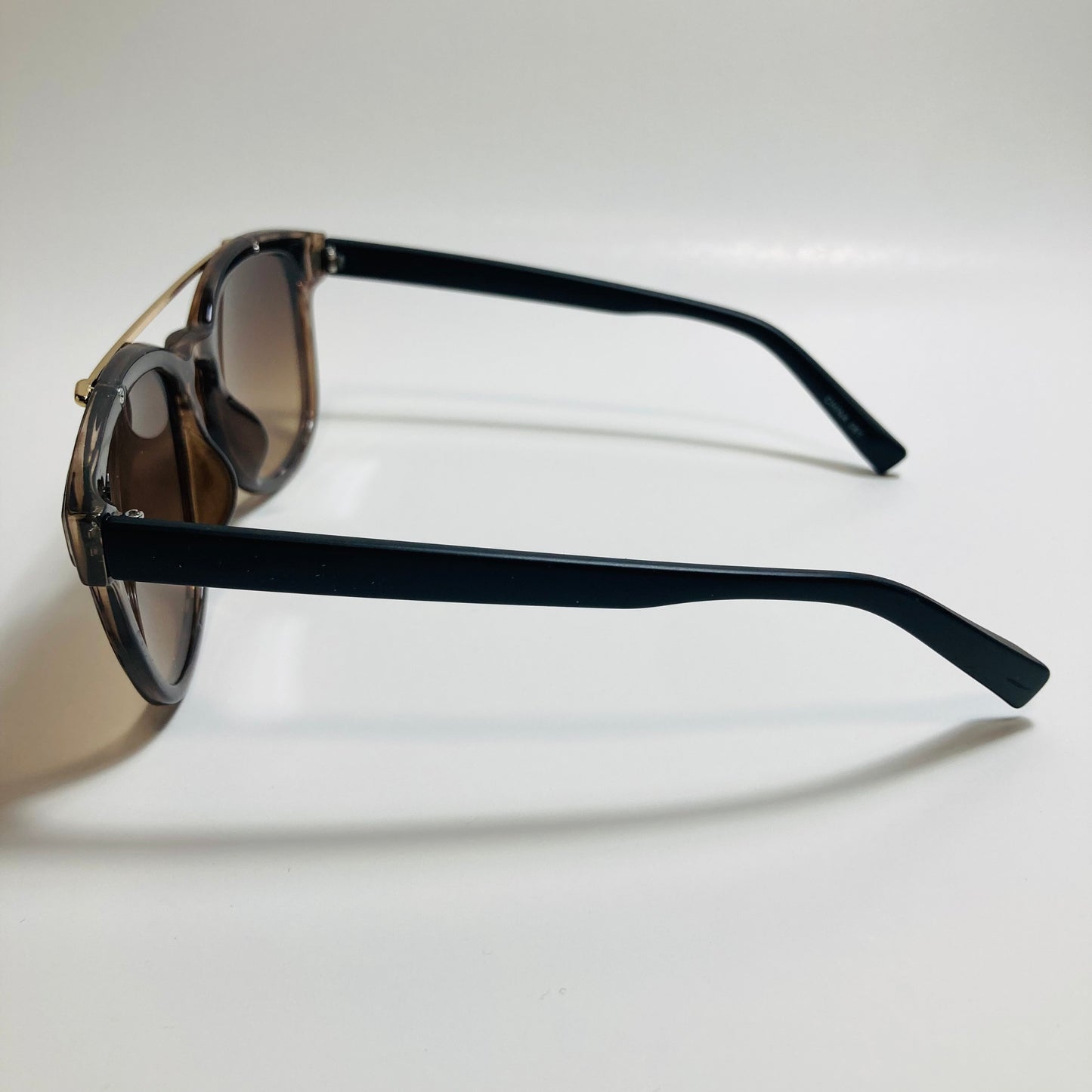 mens and womens brown and black round sunglasses with crossbar