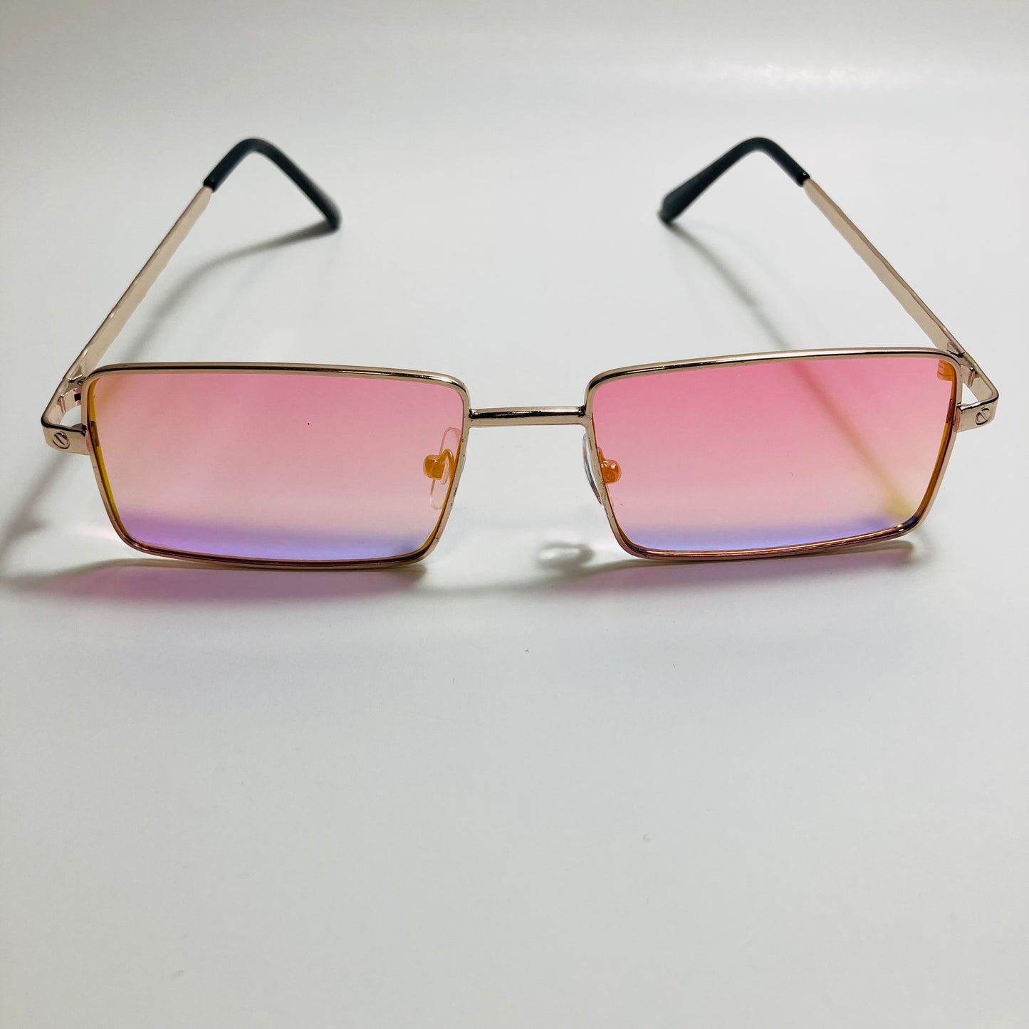 Mens and womens gold sunglasses with mirrored pink lenses
