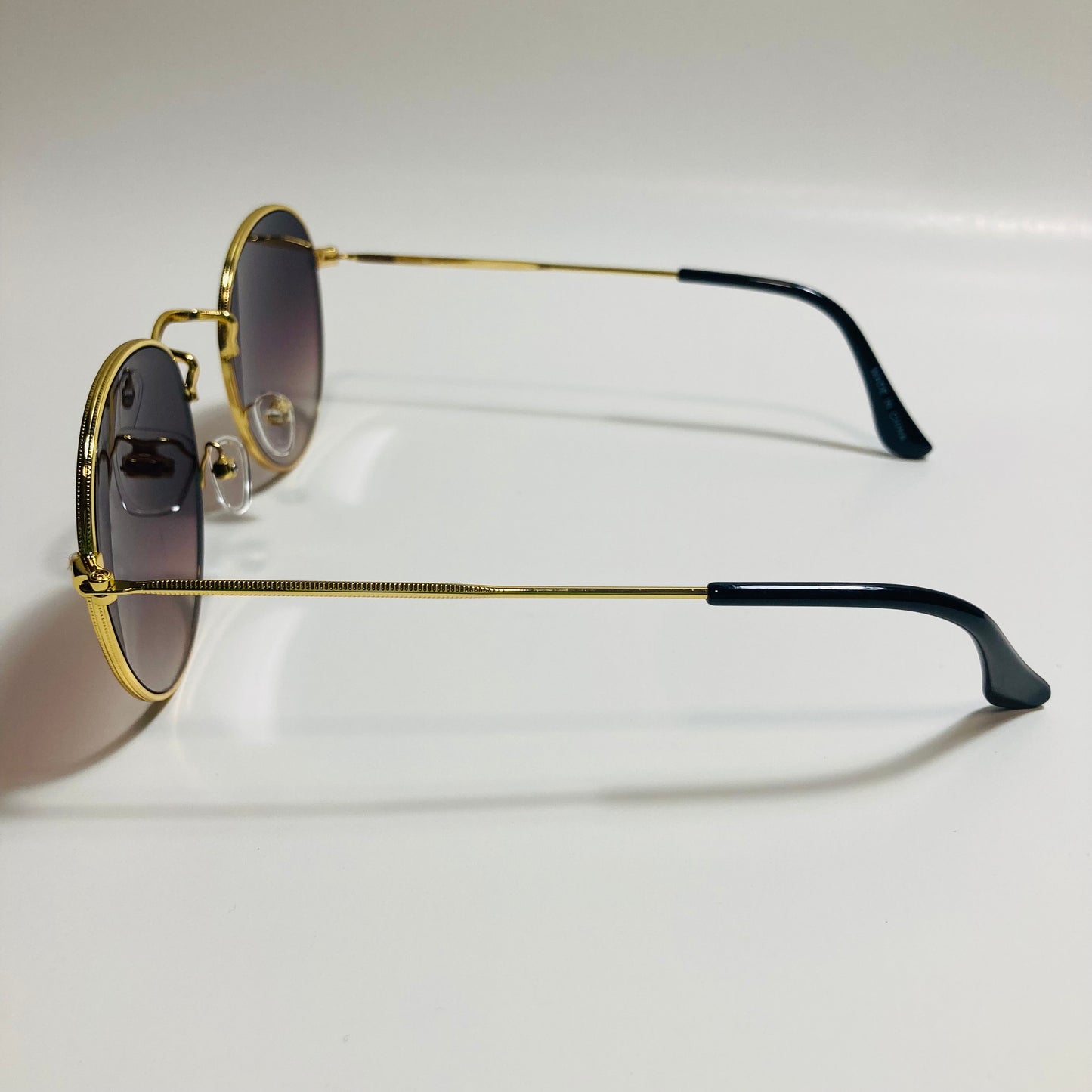 mens and womens round gold sunglasses with black lenses