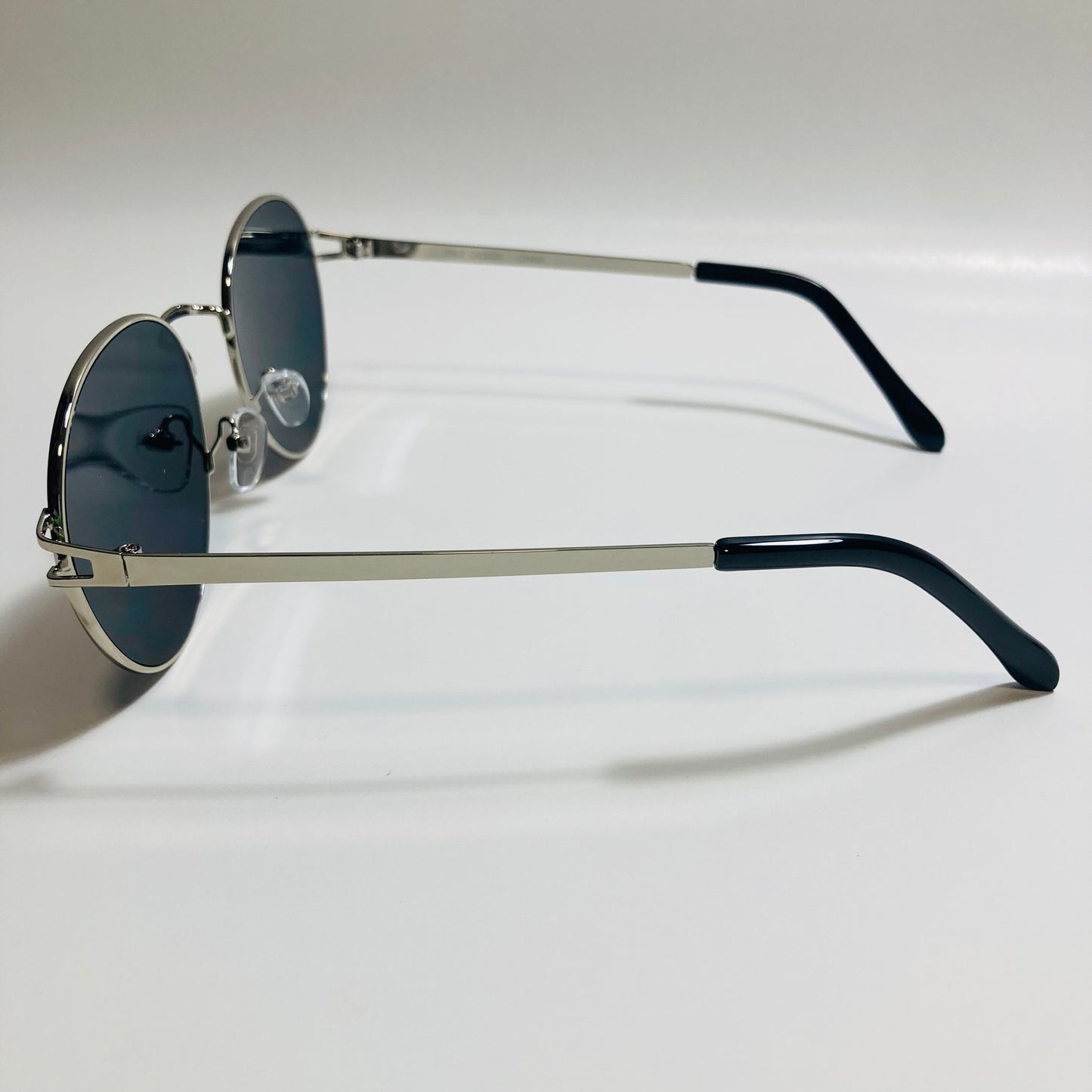 mens and womens black and silver metal round sunglasses