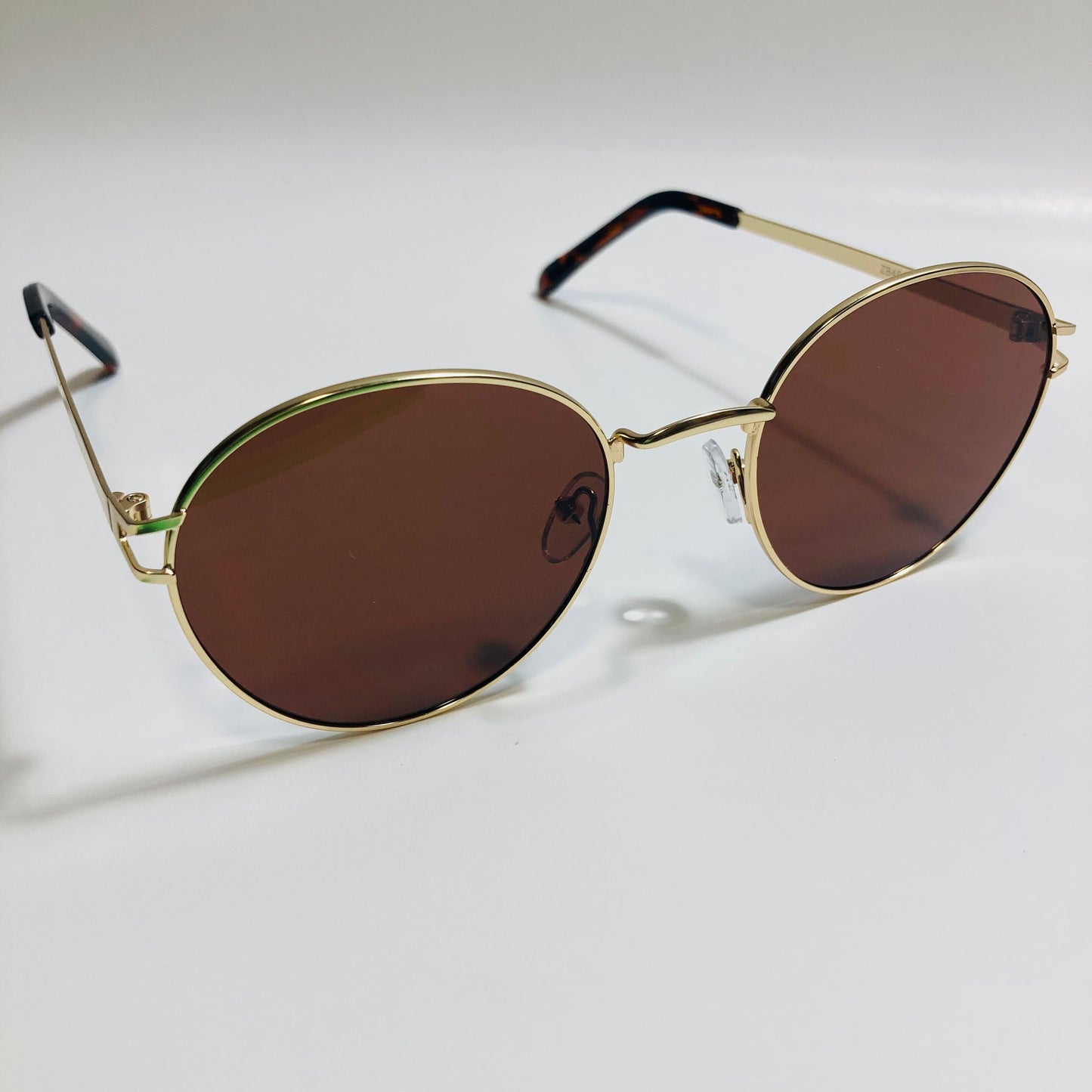 mens and womens brown and gold metal round sunglasses