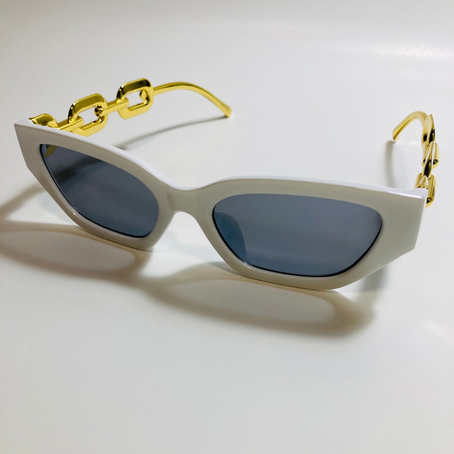 white and black square womens sunglasses with gold arms