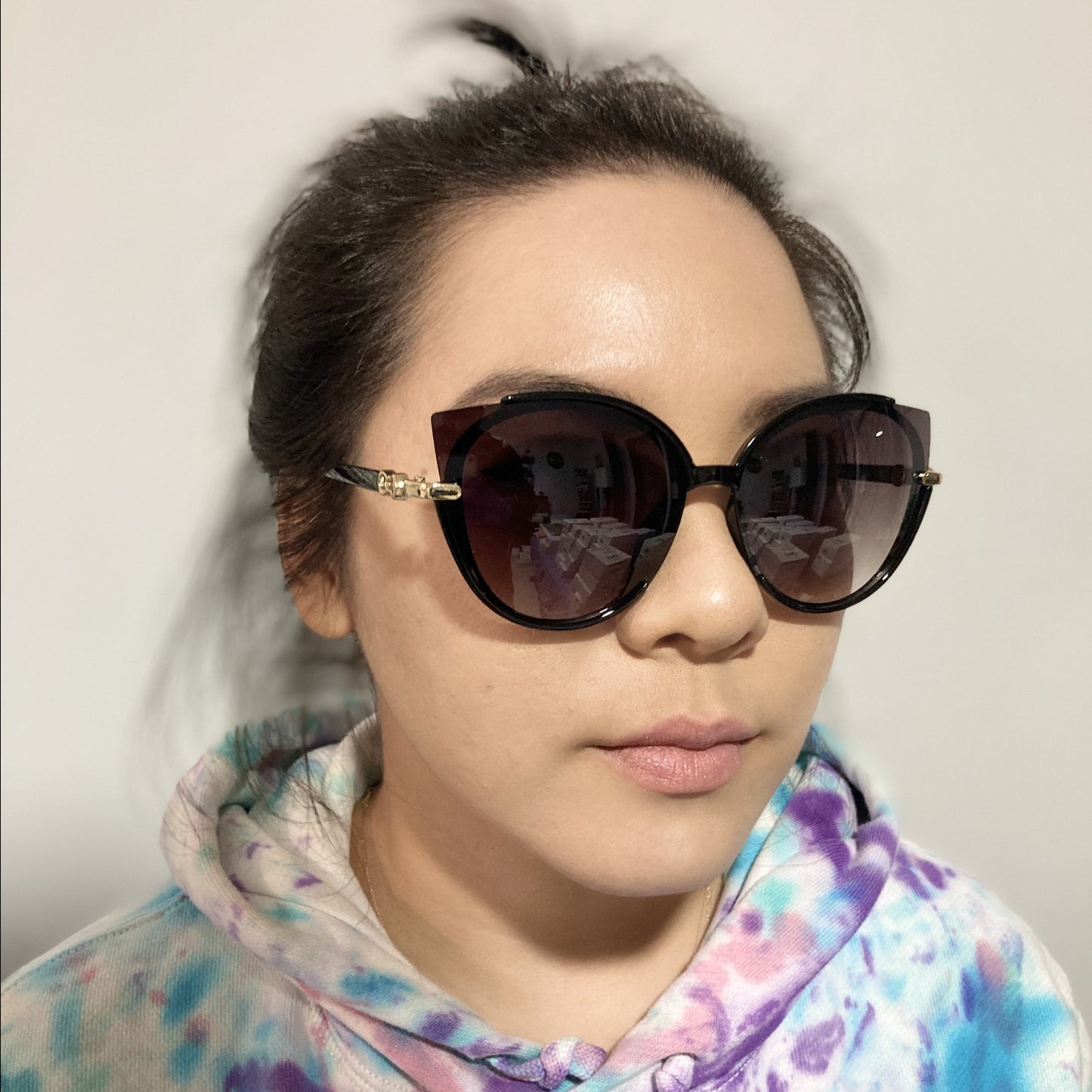 woman wearing cat eye sunglasses