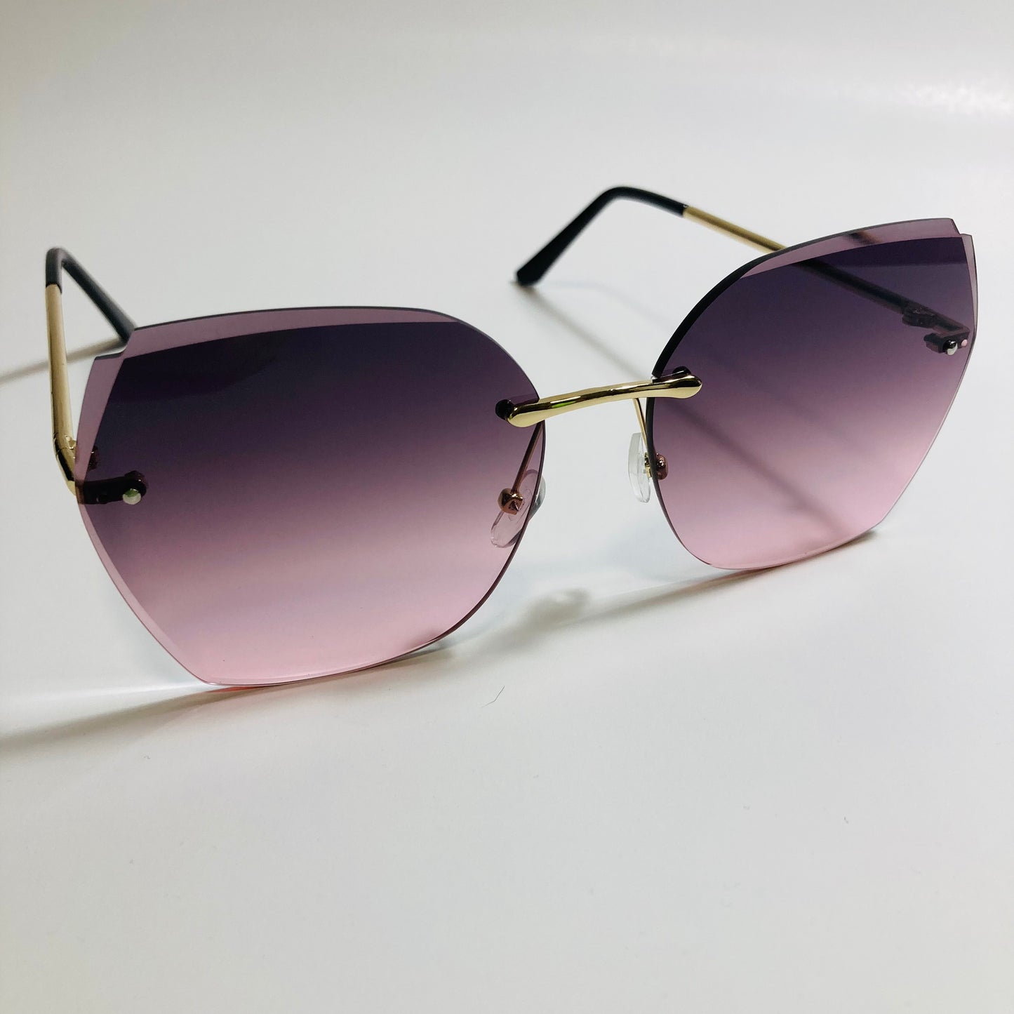 womens black and pink oversize rimless sunglasses
