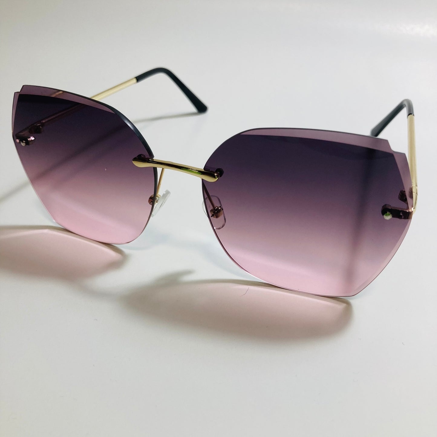 womens black and pink oversize rimless sunglasses