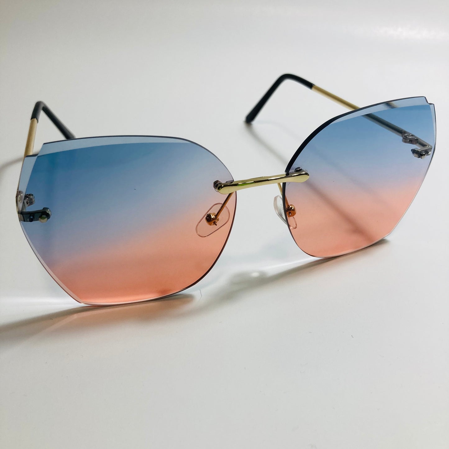 womens pink and blue oversize rimless sunglasses