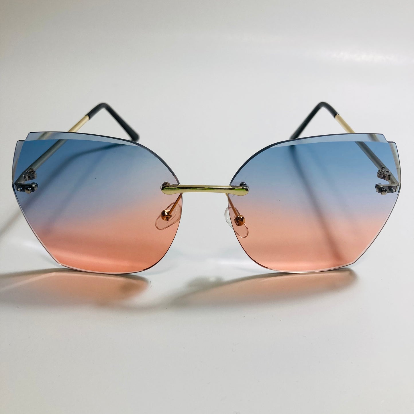 womens pink and blue oversize rimless sunglasses
